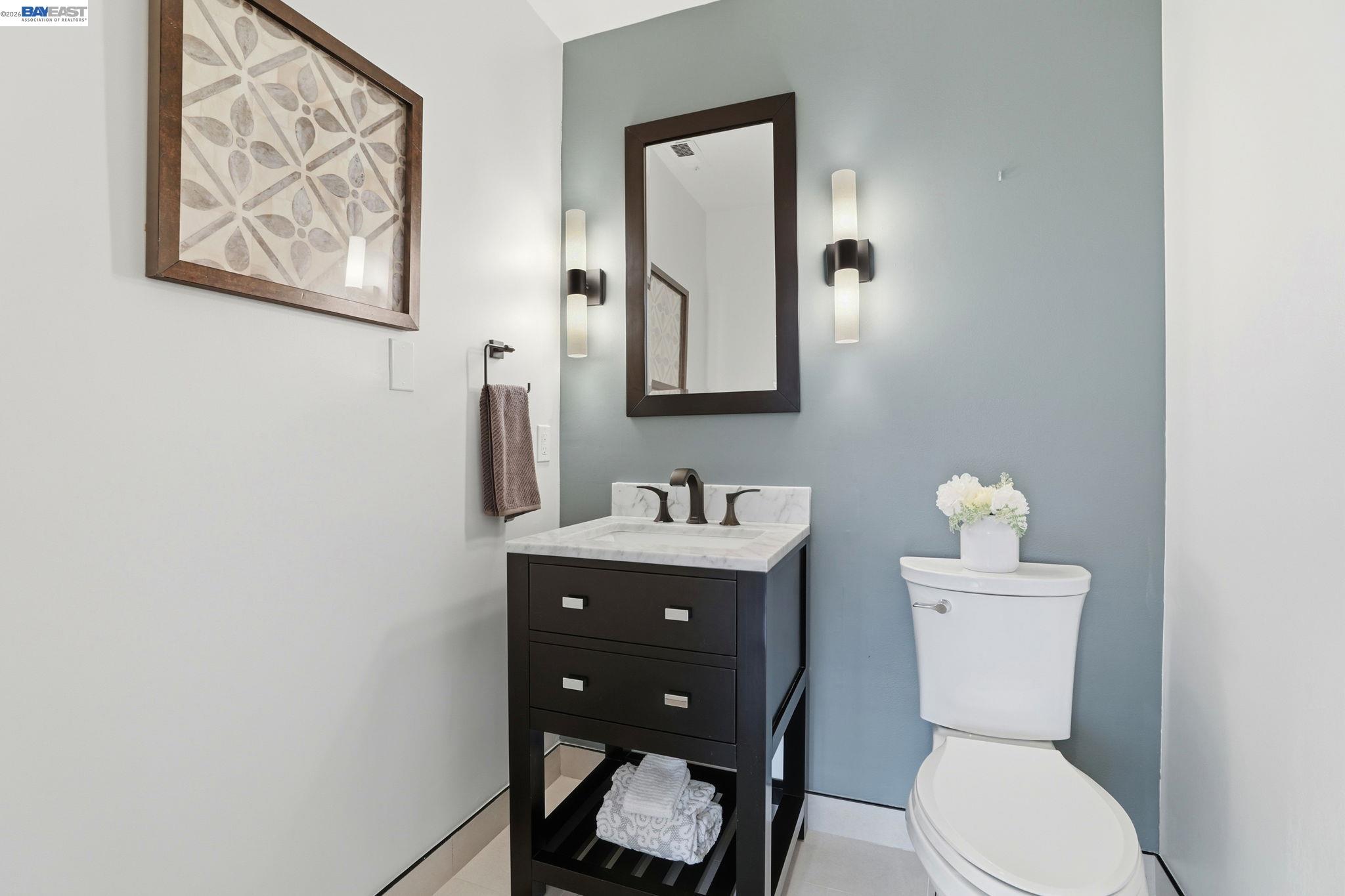 5136 Ramsgate Drive Newark, CA 94560 - Photo 36 of 59 a bathroom with a toilet a sink and mirror