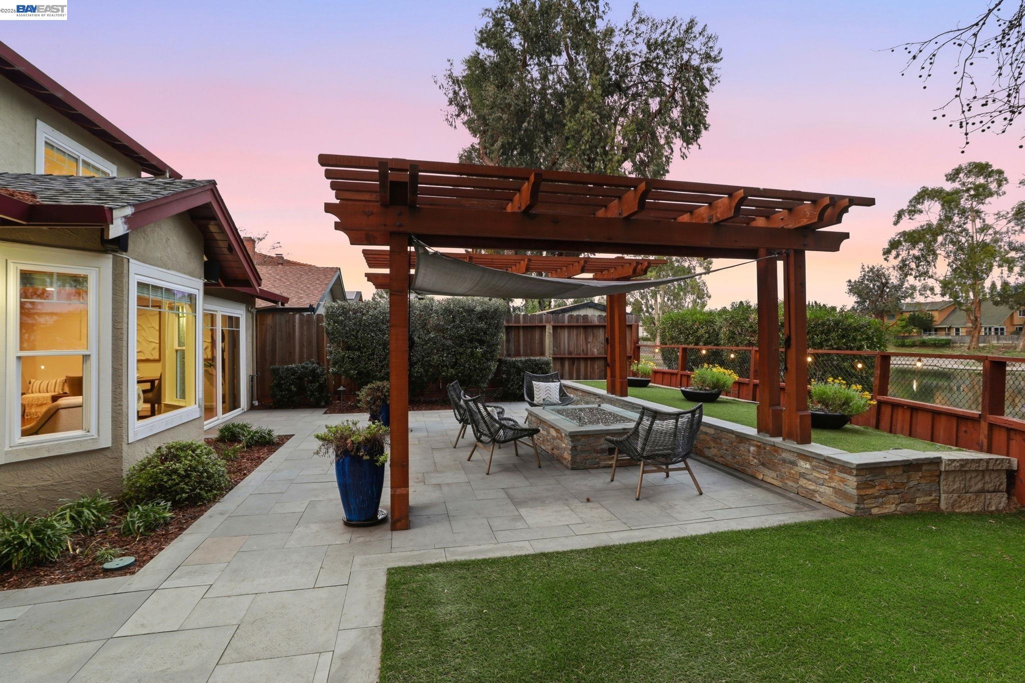 5136 Ramsgate Drive Newark, CA 94560 - Photo 41 of 59 a view of a patio with table and chairs potted plants and palm trees