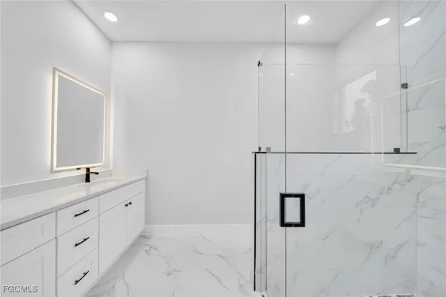 a bathroom with double sink and a mirror