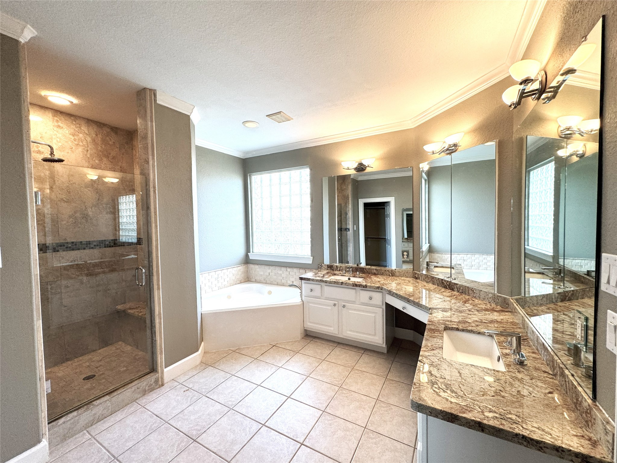 12442 Lago Bend Lane Houston, TX 77041 - Photo 16 of 31 a large bathroom with a granite countertop tub a sink and a glass door shower