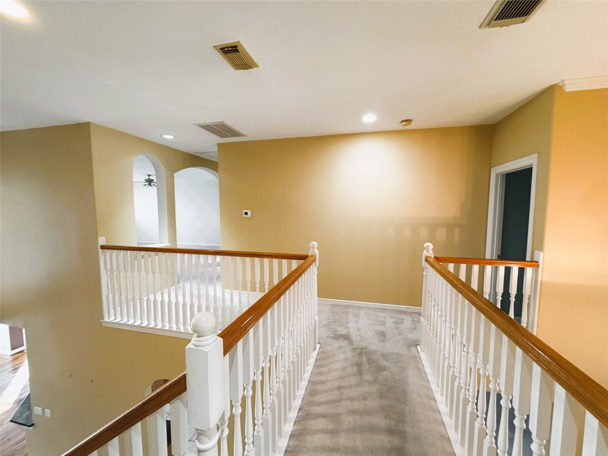 12442 Lago Bend Lane Houston, TX 77041 - Photo 20 of 31 a view of a hallway with wooden floor and staircase