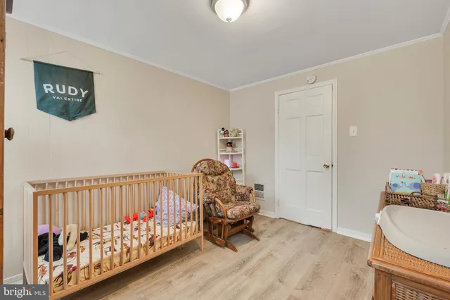 a bedroom with furniture and wooden floor