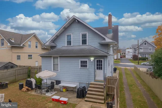 a front view of a house with table and chairs