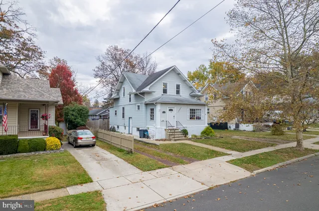a front view of a house with a yard garage and outdoor seating