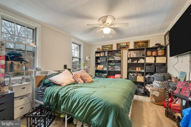 a bedroom with a bed a bookshelf and a bookshelf