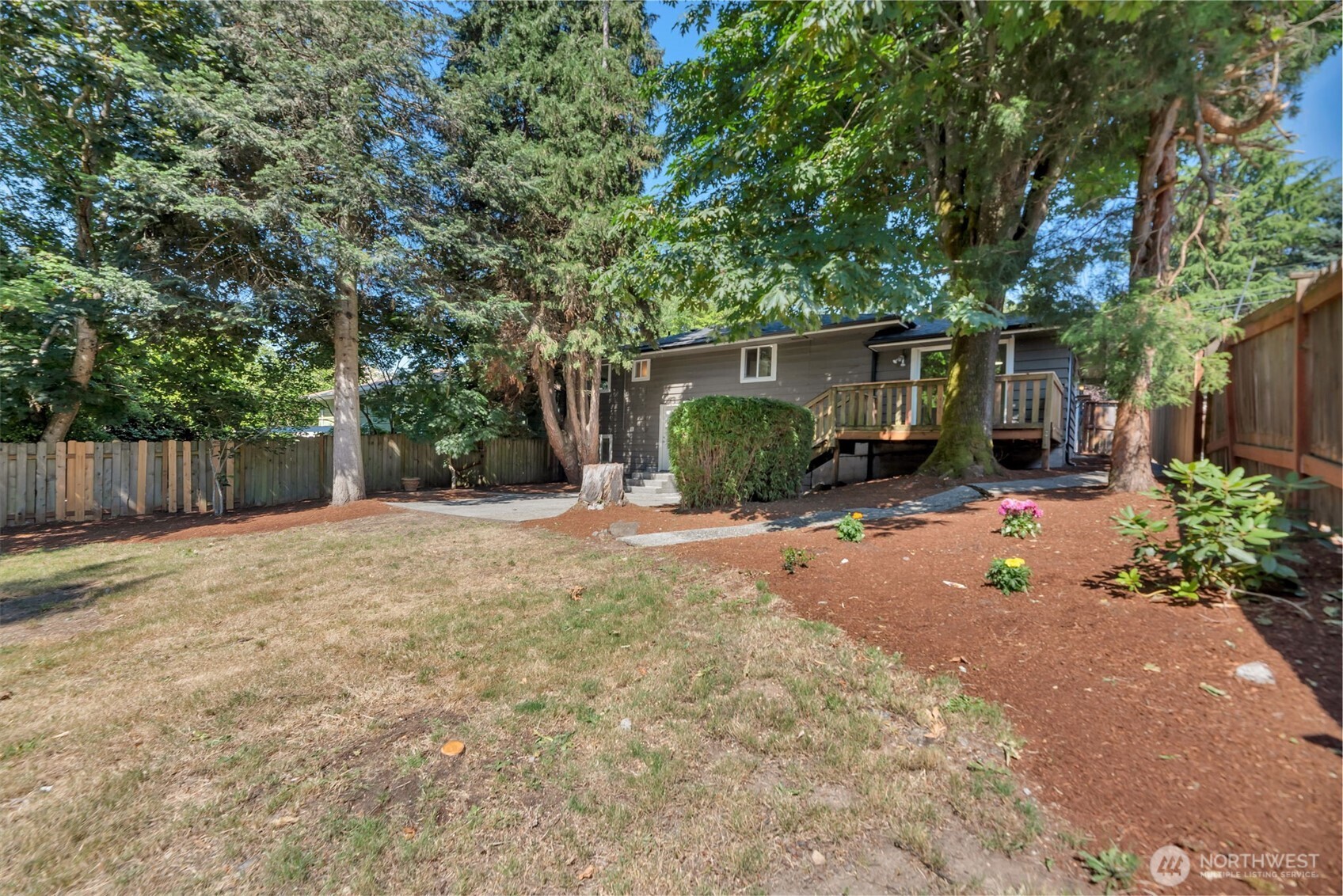 11229 29th Avenue Southwest Seattle, WA 98146 - Photo 26 of 28 a view of a backyard with potted plants and a large tree