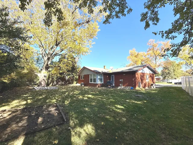 a view of a large garden with plants and large trees