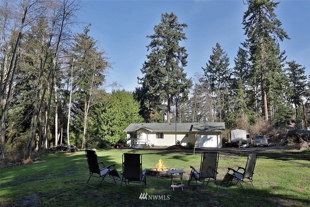 3336 East Harbor Road Langley, WA 98260 - Photo 1 of 29 a view of a lake with a table and chairs
