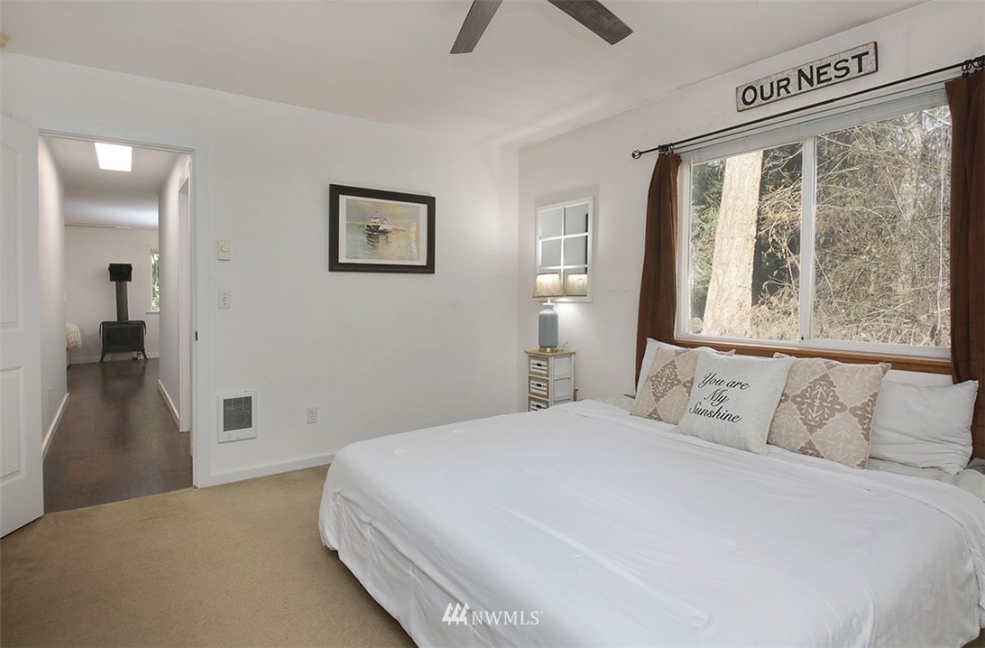 3336 East Harbor Road Langley, WA 98260 - Photo 12 of 29 a bedroom with a large bed and a window