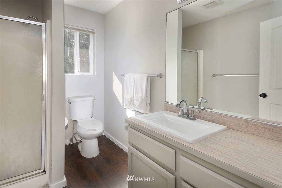 3336 East Harbor Road Langley, WA 98260 - Photo 15 of 29 a bathroom with a sink toilet and shower
