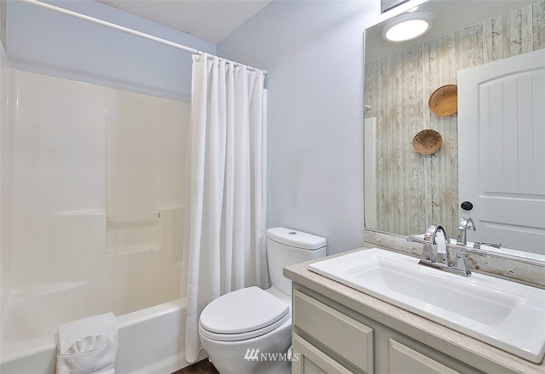 3336 East Harbor Road Langley, WA 98260 - Photo 18 of 29 a bathroom with a sink toilet and shower