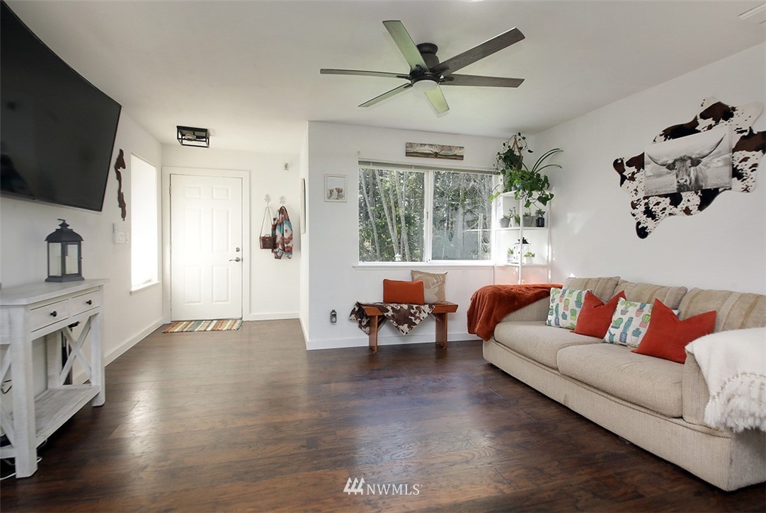 3336 East Harbor Road Langley, WA 98260 - Photo 6 of 29 a living room with furniture flat screen tv and wooden floor