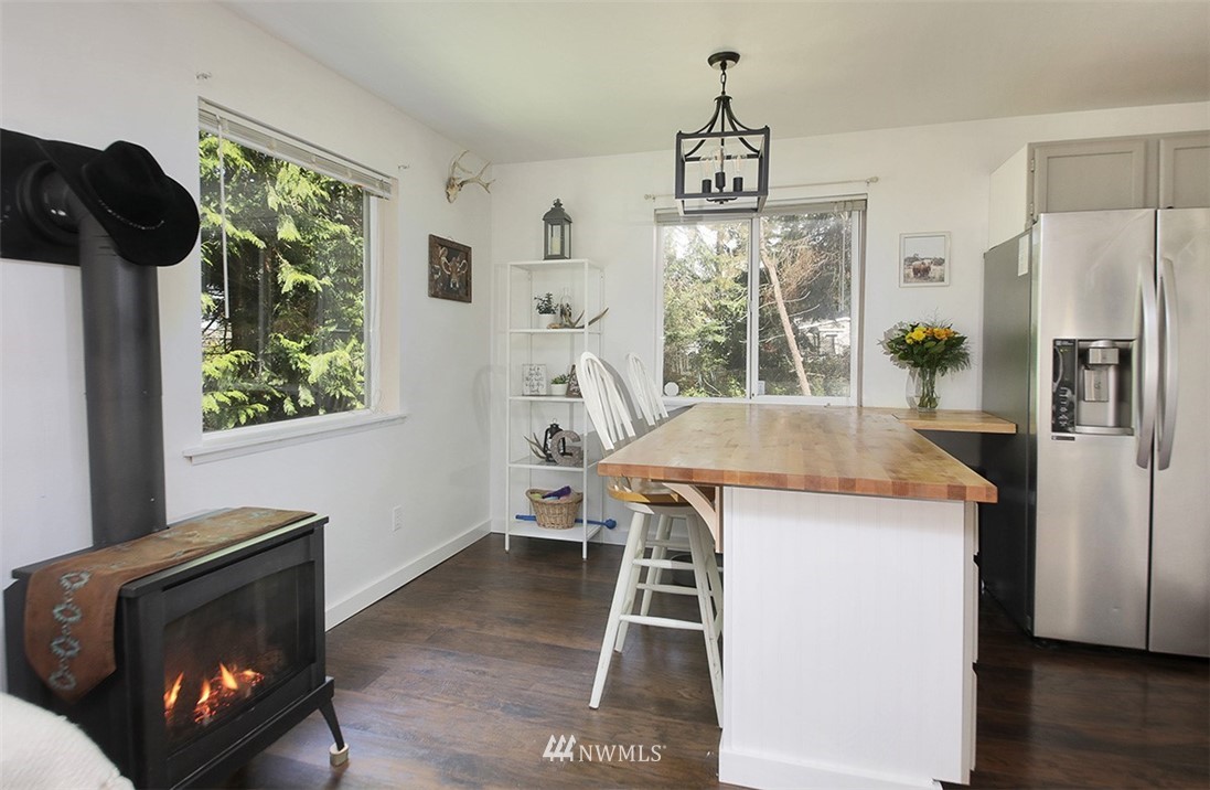 3336 East Harbor Road Langley, WA 98260 - Photo 9 of 29 a view of a dining room with furniture window and wooden floor