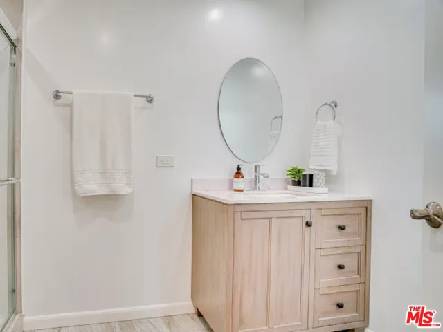 a bathroom with a sink vanity and a mirror