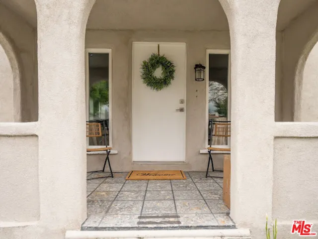 a view of a hallway with wooden floor and a living room