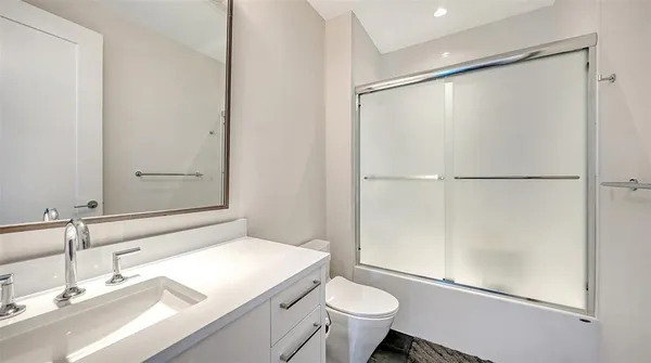 a bathroom with a sink toilet and shower
