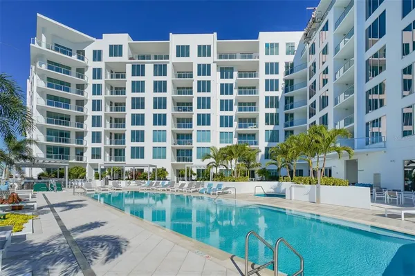 a view of building with swimming pool and sitting area