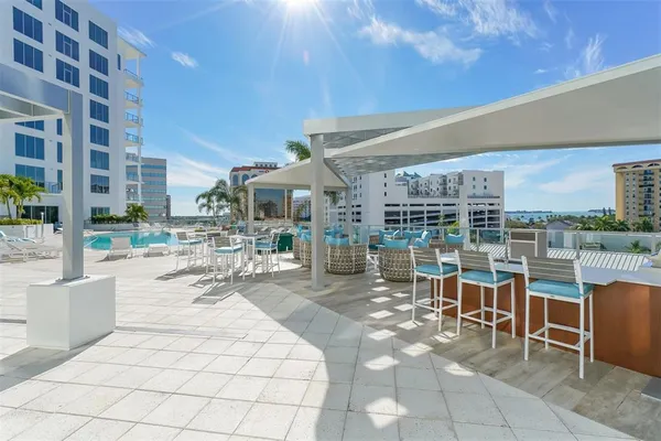 a view of a patio with a dining table and chairs with wooden fence