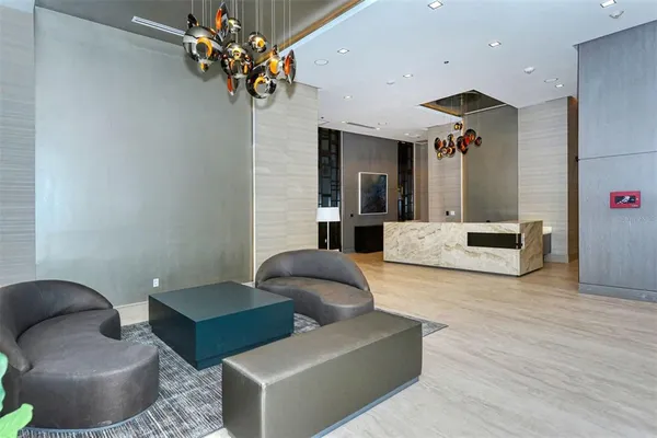 a living room with furniture and a chandelier