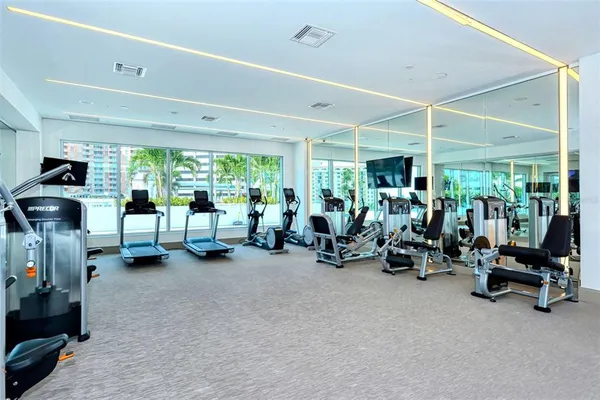 a view of a room with gym equipment and a large window