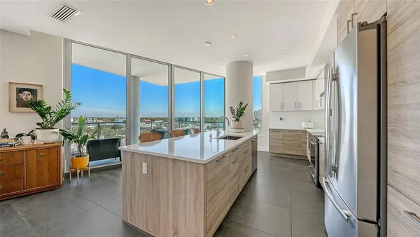 a living room with stainless steel appliances kitchen island granite countertop furniture and a kitchen view
