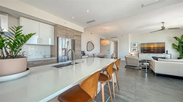 a kitchen view living space with furniture and flat screen tv