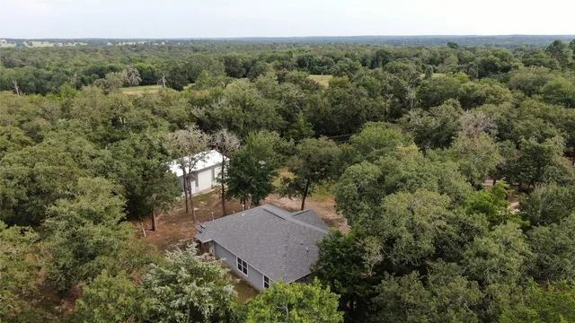 an aerial view of a house with yard