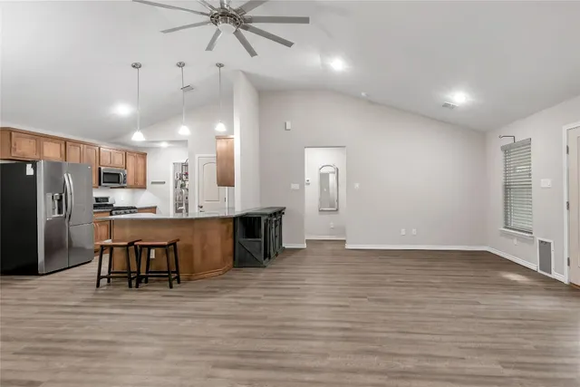 a view of kitchen with refrigerator microwave and cabinets