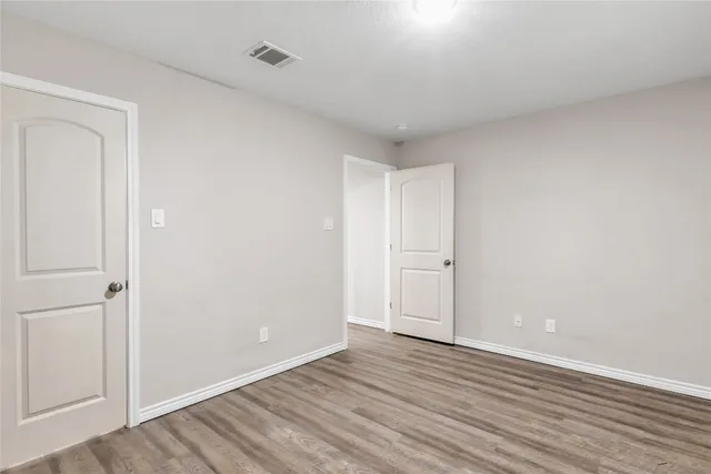 a view of an empty room and wooden floor