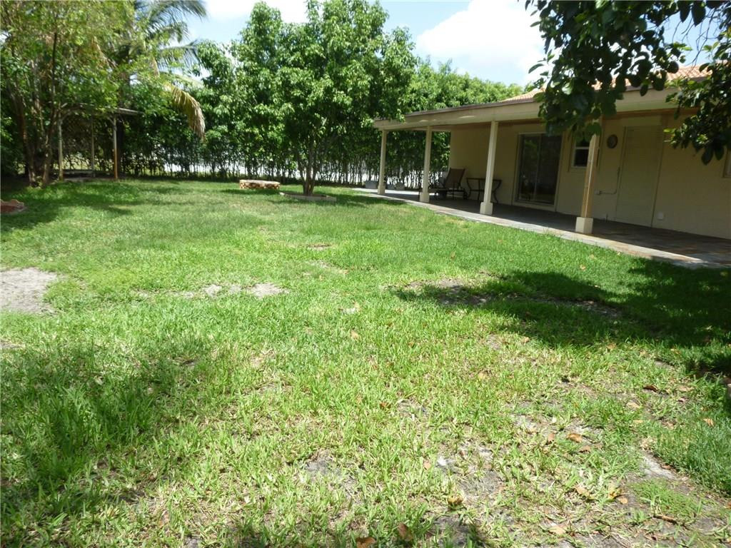 7305 Northwest 95th Way Tamarac, FL 33321 - Photo 14 of 14 a backyard of a house with plants and large tree