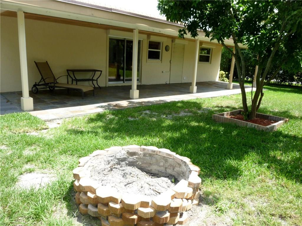 7305 Northwest 95th Way Tamarac, FL 33321 - Photo 10 of 14 a backyard of a house with table and chairs