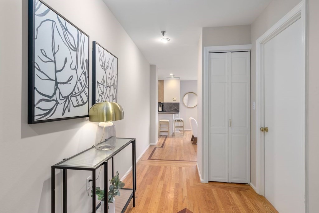 350 North Street, Unit 400 Boston, MA 02113 - Photo 13 of 24 a view of a hallway with wooden floor and chair