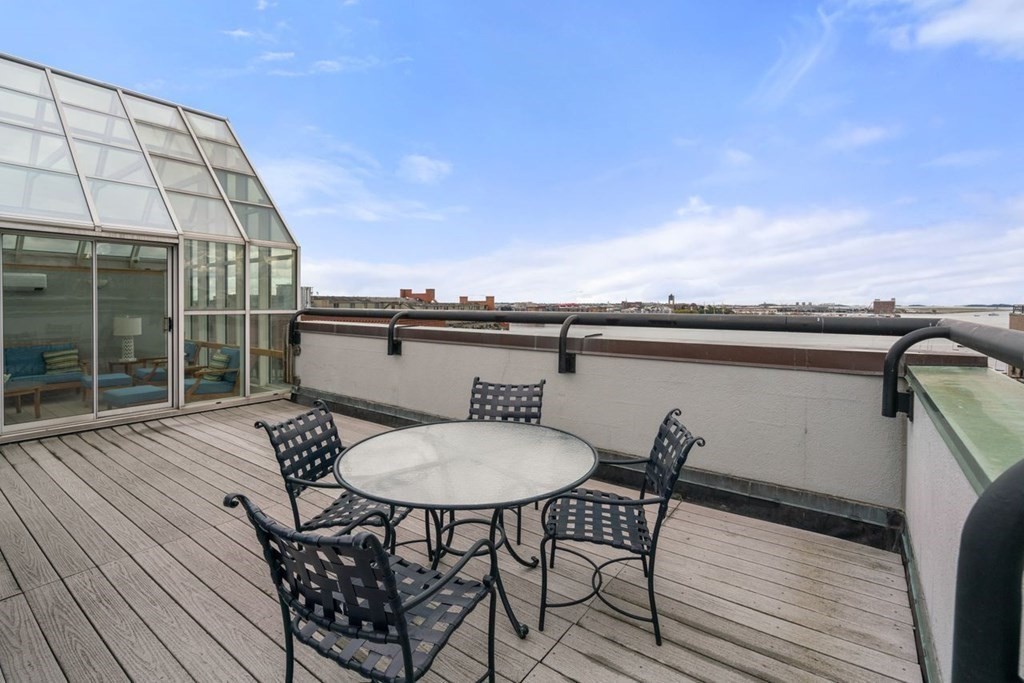 350 North Street, Unit 400 Boston, MA 02113 - Photo 20 of 24 a balcony with table and chairs