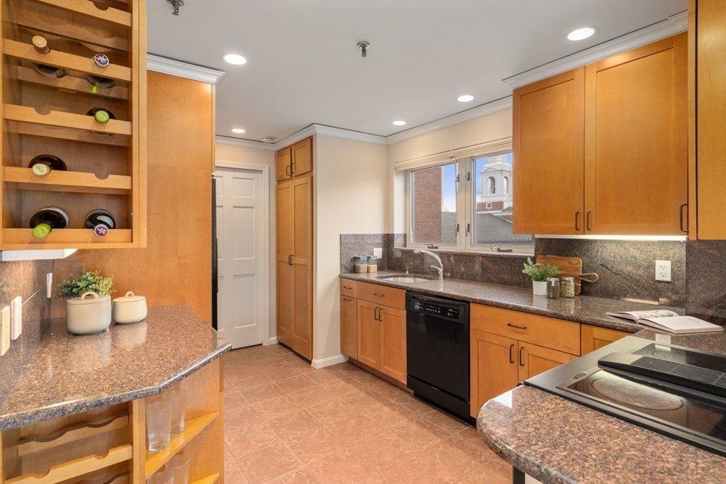 350 North Street, Unit 400 Boston, MA 02113 - Photo 5 of 24 a kitchen with stainless steel appliances granite countertop a sink and cabinets