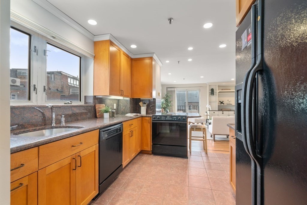 350 North Street, Unit 400 Boston, MA 02113 - Photo 6 of 24 a kitchen with stainless steel appliances granite countertop a refrigerator a sink a stove and oven