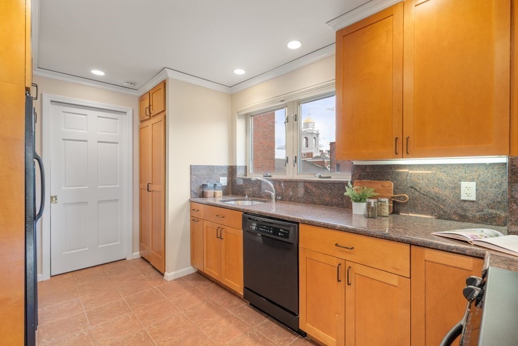 350 North Street, Unit 400 Boston, MA 02113 - Photo 7 of 24 a kitchen with granite countertop a sink and cabinets