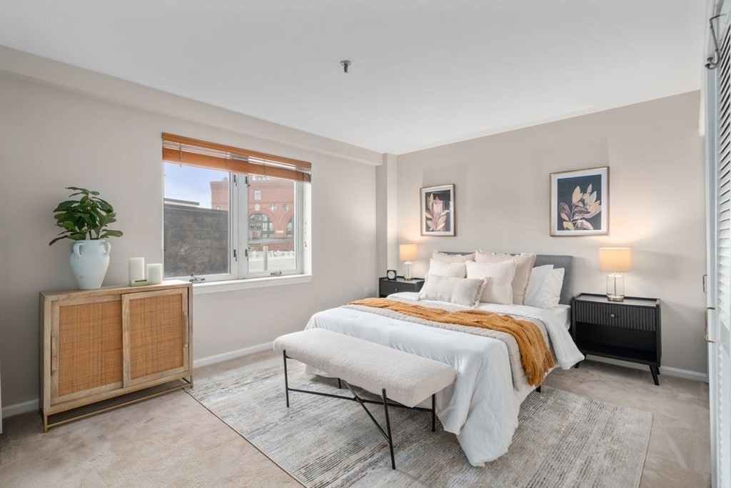 350 North Street, Unit 400 Boston, MA 02113 - Photo 9 of 24 a bedroom with a bed and a table