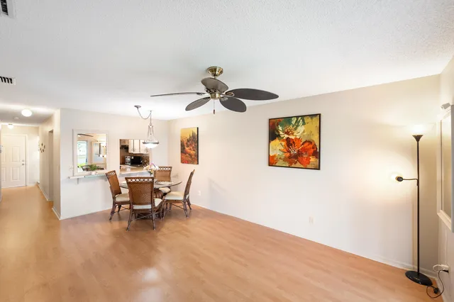 a view of a livingroom with furniture and a ceiling fan