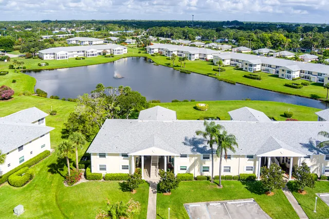 an aerial view of residential houses with outdoor space and swimming pool