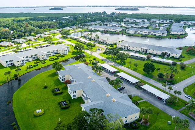 an aerial view of a house with a swimming pool outdoor seating and yard