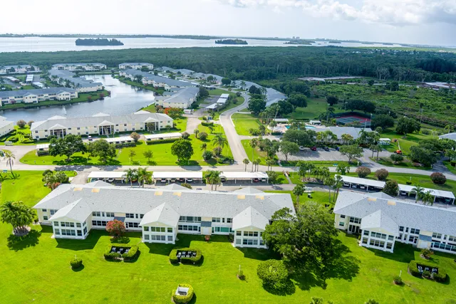 an aerial view of residential houses with outdoor space and swimming pool