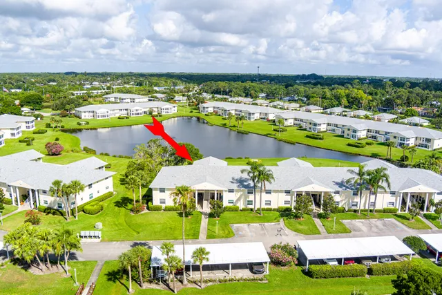 an aerial view of residential houses with outdoor space and ocean view