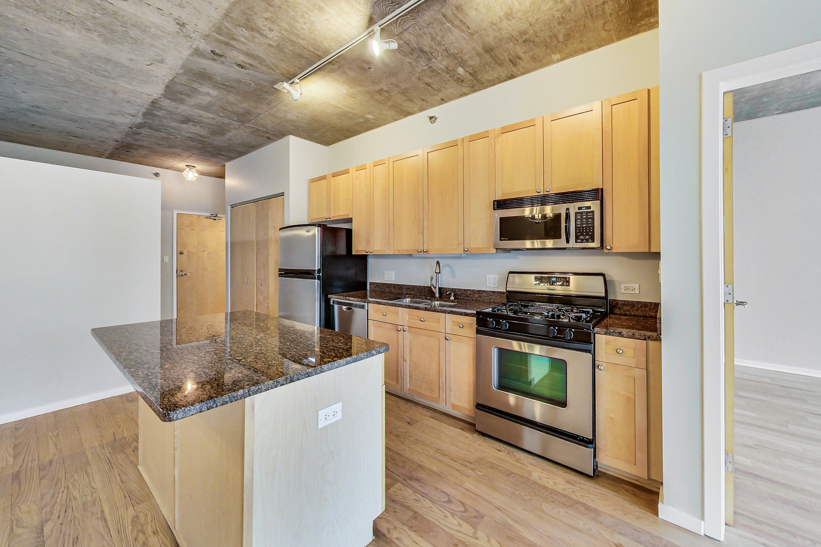 321 South Sangamon Street, Unit 408 Chicago, IL 60607 - Photo 14 of 31 a kitchen with stainless steel appliances granite countertop a stove a sink and a microwave