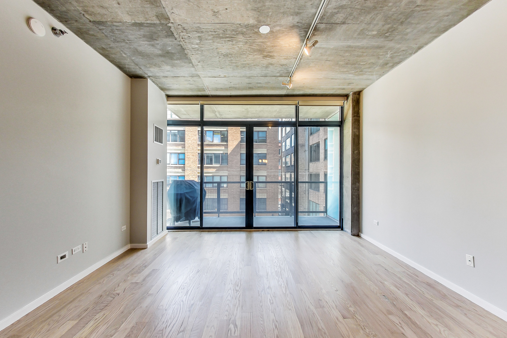 321 South Sangamon Street, Unit 408 Chicago, IL 60607 - Photo 8 of 31 wooden floor in an empty room with a window