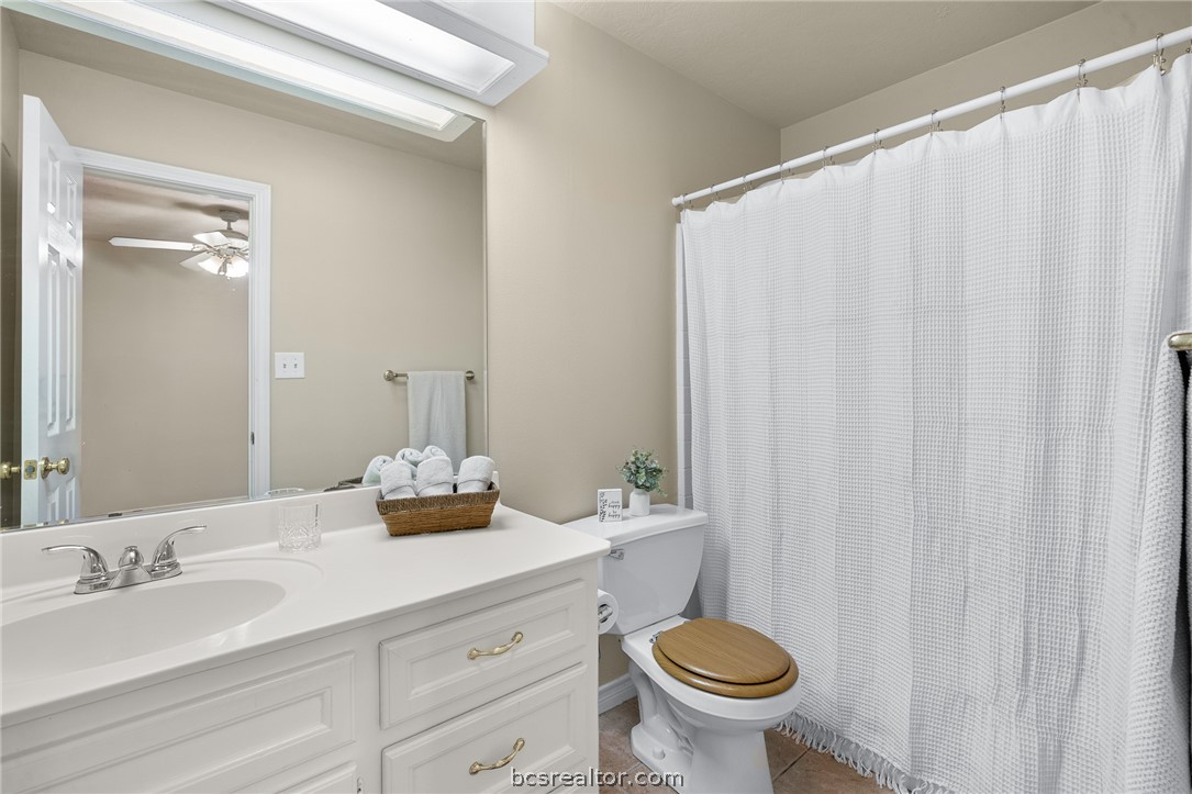 2287 North Earl Rudder Freeway Bryan, TX 77803 - Photo 15 of 32 a bathroom with a granite countertop sink and a mirror