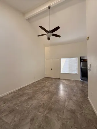 a view of a big room with a ceiling fan
