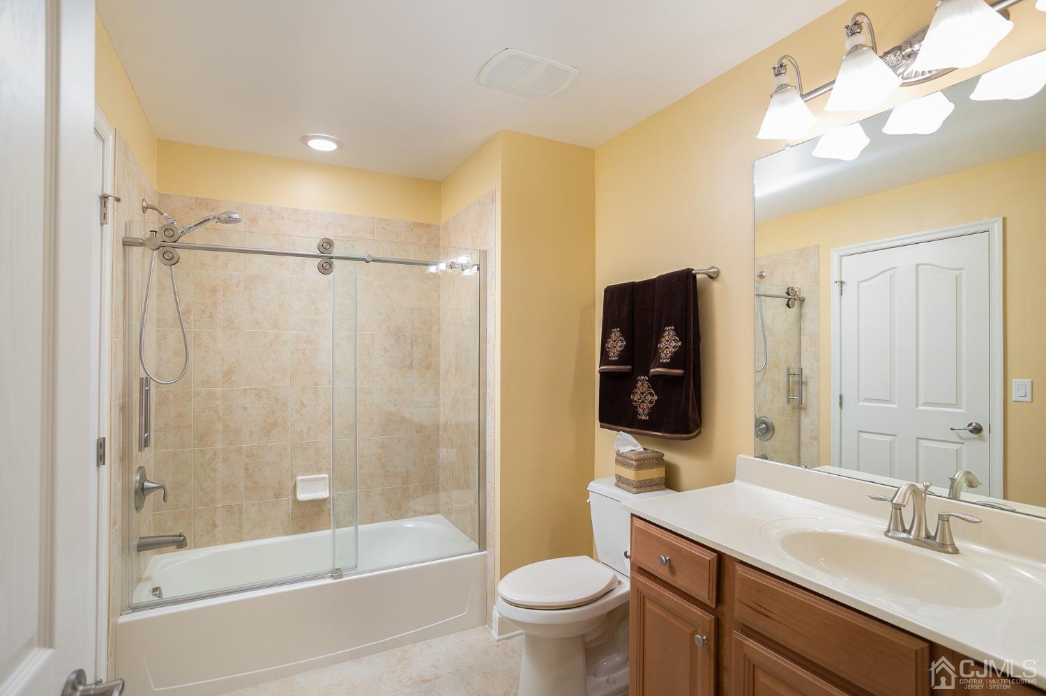 93 Timber Hill Drive Monroe Township, NJ 08831 - Photo 27 of 40 a bathroom with a bathtub shower sink vanity and toilet