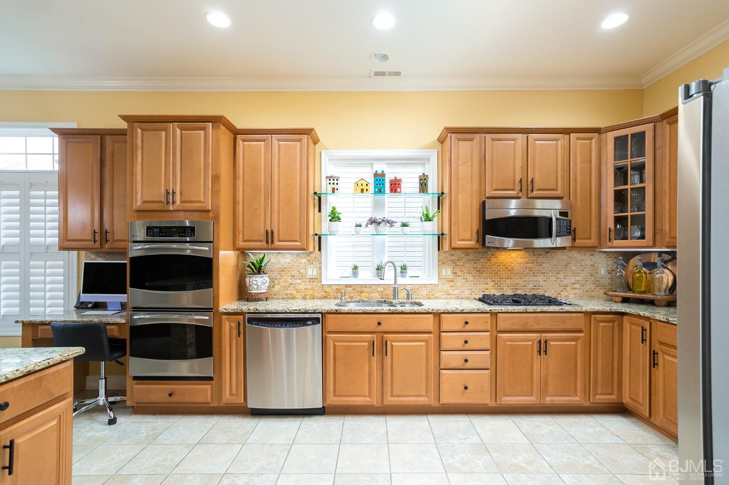 93 Timber Hill Drive Monroe Township, NJ 08831 - Photo 3 of 40 a kitchen with stainless steel appliances a stove sink and microwave