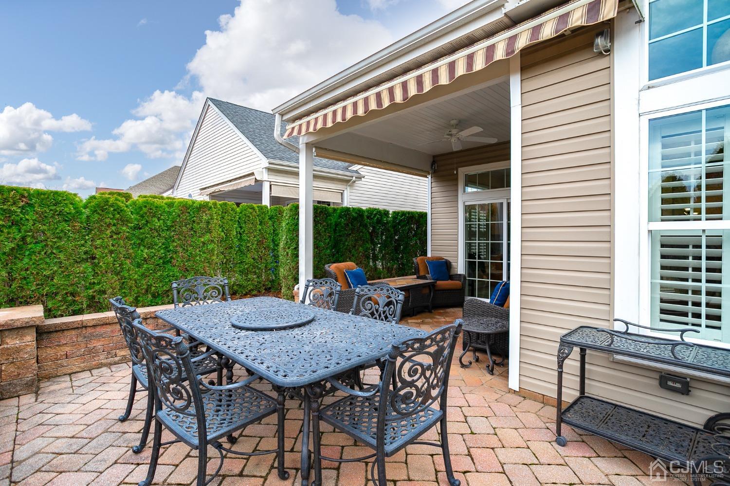 93 Timber Hill Drive Monroe Township, NJ 08831 - Photo 32 of 40 a view of a patio with a table and chairs under an umbrella