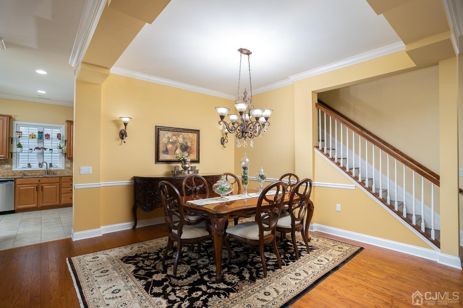 93 Timber Hill Drive Monroe Township, NJ 08831 - Photo 9 of 40 a dining room with chandelier and wooden floor